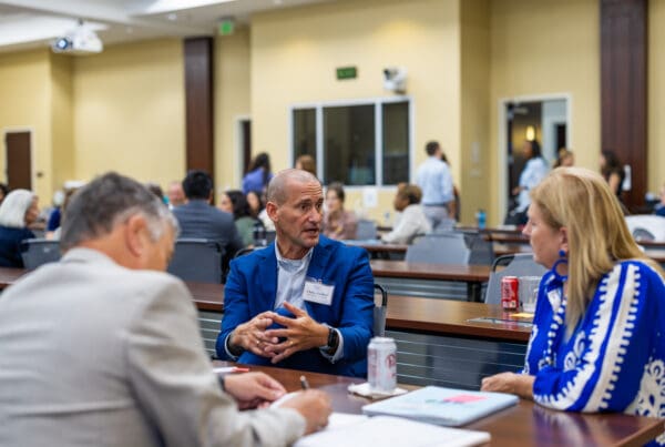 A group of grantees engaged in deep conversation during the networking event.